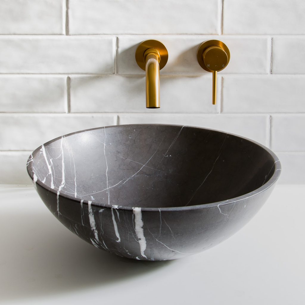black marble basin and gold taps